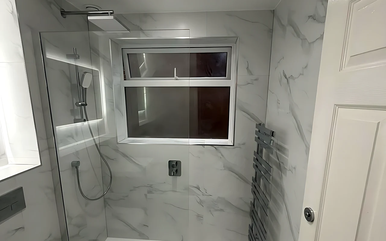 Billericay bathroom with a walk-in shower under the window and marble-effect tiles