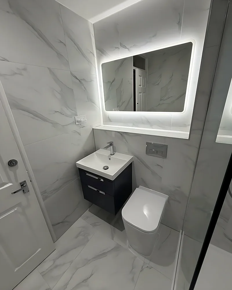 Wall-hung vanity under an LED mirror
