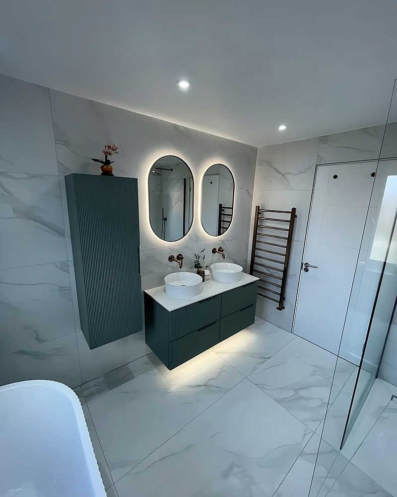 Basin, brushed brass tap and LED mirror