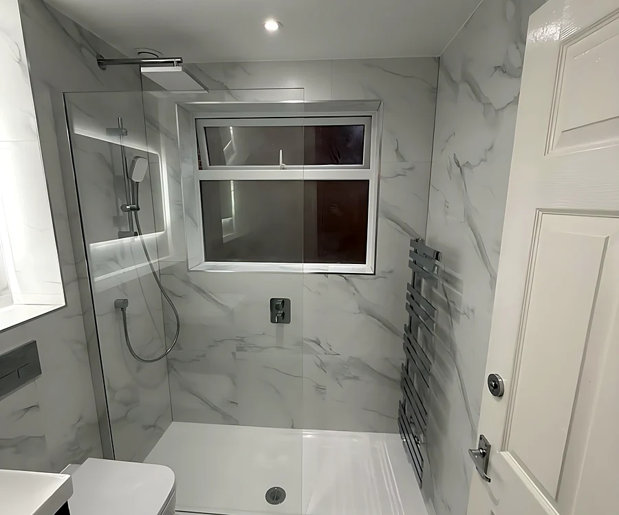 Billericay bathroom with a walk-in shower under the window and marble-effect tiles