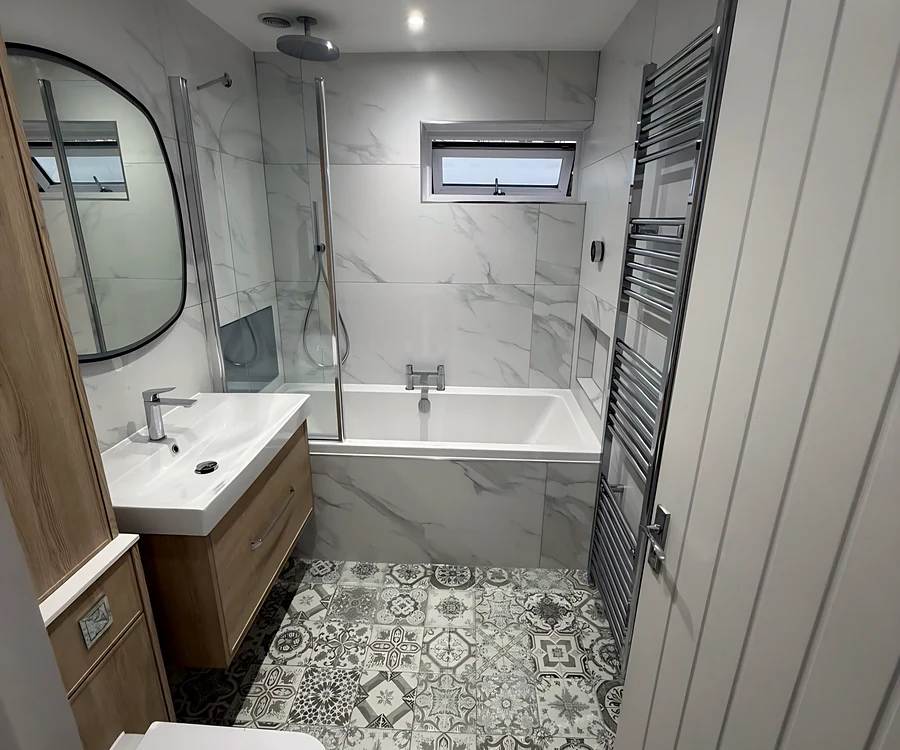 Hatfield Peverel bathroom with a patterned floor, a shower bath and a wood vanity