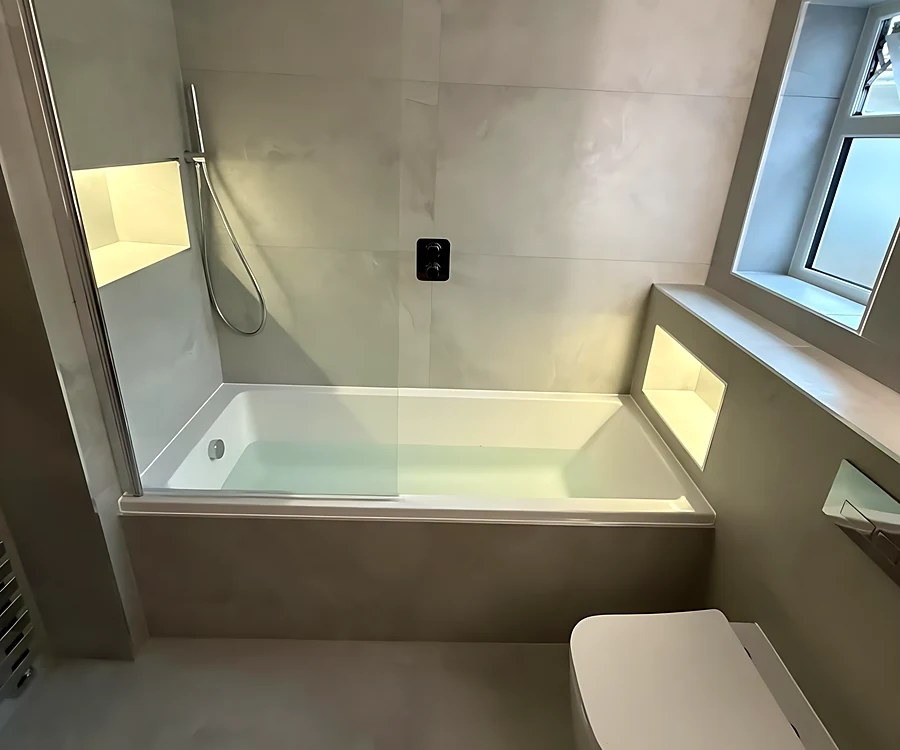 Leigh-on-Sea bathroom with a shower bath under the window and a lit niche