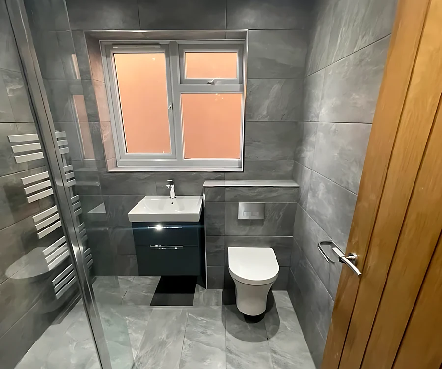 Wickford bathroom with large-format grey tiles, a wall-hung vanity and a walk-in shower