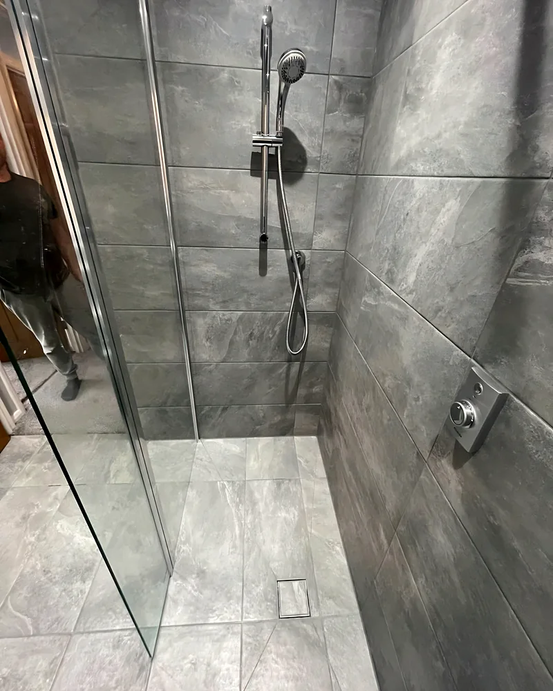 Walk-in shower with a glass panel