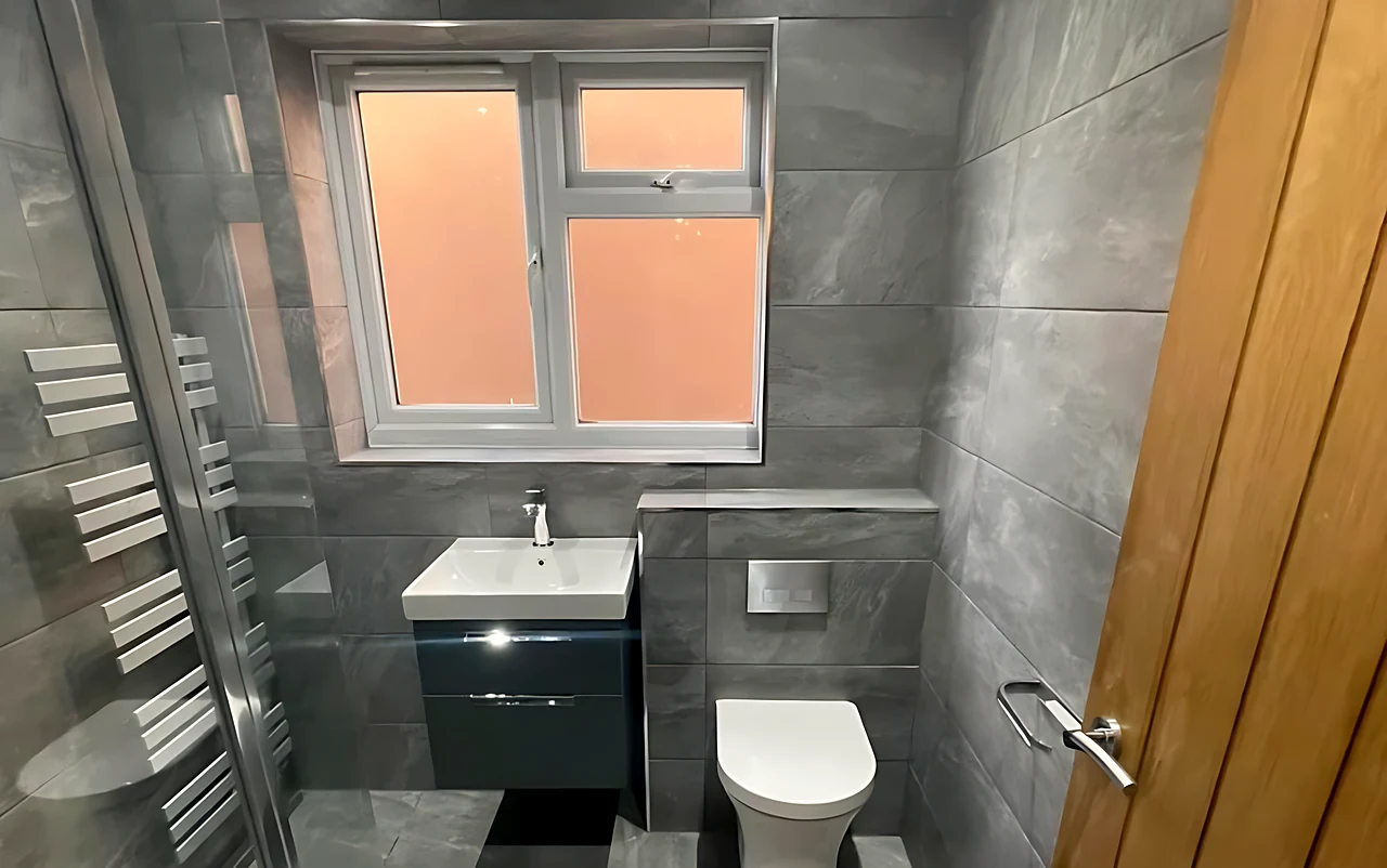 Wickford bathroom with large-format grey tiles, a wall-hung vanity and a walk-in shower